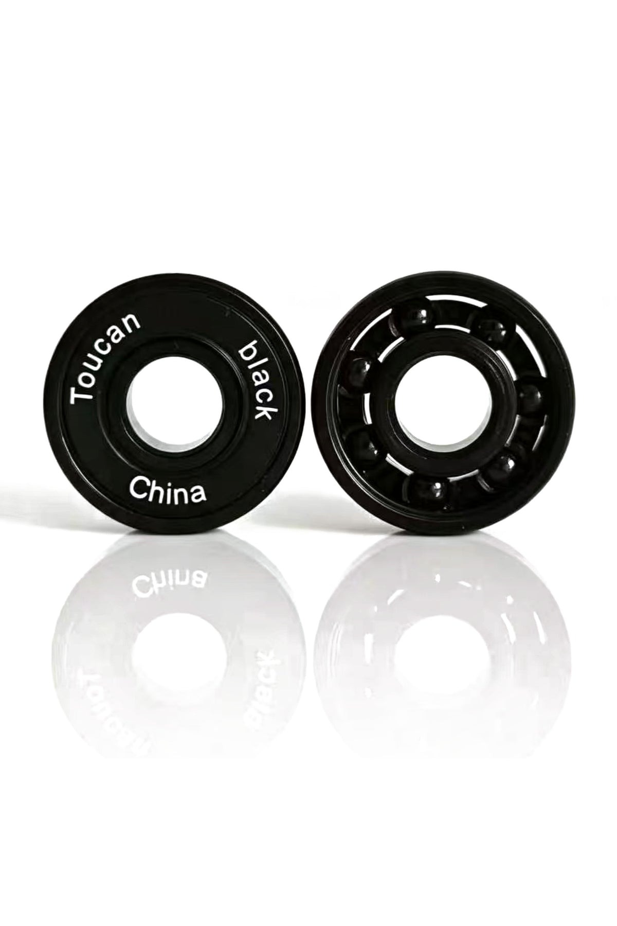 Toucan Black Pro ABEC-9 bearings, one with its rubber seal and one open showing the black ceramic balls